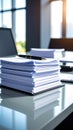 Stack of documents and pen on a table in a bright office environment. Royalty Free Stock Photo