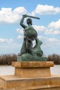 Generated Image A statue of a mermaid with a sword against the background of a bridge. Warsaw.