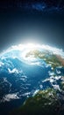 Stunning view of Earth from space with sun breaking over the horizon illuminating continents oceans and clouds under Royalty Free Stock Photo