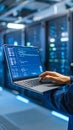 Technician working on laptop in server room with data center equipment. Royalty Free Stock Photo