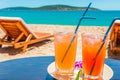 Two glasses of refreshing drinks or cocktails on a table on the beach of a tropical resort Royalty Free Stock Photo