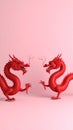Two Red Dragons Facing Each Other on Pink Background Symbolizing Strength and Power Royalty Free Stock Photo
