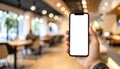 Over-the-Shoulder Smartphone Mockup Sleek Black Phone with Blank Screen in Modern Cafe Royalty Free Stock Photo