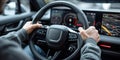 Focus on a drivers hands on the wheel with a modern dashboard in front of them Royalty Free Stock Photo