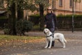 Visually impaired woman walking in park with a guide dog assistance Royalty Free Stock Photo