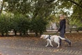 Visually impaired woman walking in park with a guide dog assistance Royalty Free Stock Photo