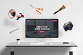 Web design studio page on display with flying concept web tools: megaphone, scissors, brush, photo camera, wrench key Royalty Free Stock Photo