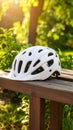 White Bicycle Helmet Resting on a Bench in Green Park Safe Cycling Concept Royalty Free Stock Photo