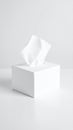 White tissue box with a single tissue pulled out on a white surface Royalty Free Stock Photo