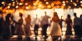 Blurred figures of people dancing in a hall with glowing bokeh lights capturing the warm festive atmosphere of a joyous Royalty Free Stock Photo