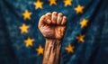 Clenched fist raised in front of the European Union flag, symbolizing solidarity, strength, unity, and the fight for Royalty Free Stock Photo