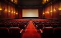 Empty cinema theater with red seats curtains and a blank white screen ready for the audience to enjoy a movie