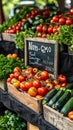Fresh organic produce on display at a local farmers market with a prominent Non-GMO sign among vibrant tomatoes, zucchinis Royalty Free Stock Photo