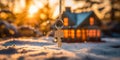 Golden winter sunrise illuminates a house-shaped key evoking the warmth of a cozy home amidst a snowy landscape symbolizing Royalty Free Stock Photo