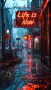 Illuminated neon sign in a rainy cityscape boldly declaring Life is Now, emphasizing the concept of living in the moment and Royalty Free Stock Photo