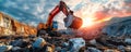 Industrial excavator on construction site against a vibrant sunset, depicting heavy machinery at work in mining operations Royalty Free Stock Photo