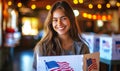 Joyful young woman exercising her civic duty with a smile, casting a ballot at a voting booth adorned with American flags during Royalty Free Stock Photo