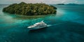 Luxury Yacht anchored in tropical paradise. Aerial view of yacht surrounded by crystal-clear turquoise waters anchored in a Royalty Free Stock Photo