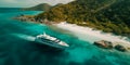 Luxury Yacht anchored in tropical paradise. Aerial view of yacht surrounded by crystal-clear turquoise waters anchored in a Royalty Free Stock Photo