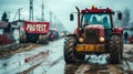 Rugged tractor with a PROTEST sign on muddy rural road during a demonstration, symbolizing agricultural activism and the Royalty Free Stock Photo