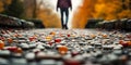 Symbolic journey of overcoming drug addiction with scattered pills on the ground and a person walking towards freedom in autumn Royalty Free Stock Photo