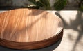 Teak wooden round smooth beautiful grain podium table tray in sunlight shadow on blank polished concrete floor for luxury organic
