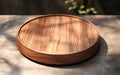 Teak wooden round smooth beautiful grain podium table tray in sunlight shadow on blank polished concrete floor for luxury organic