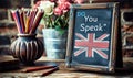 Vintage chalkboard with Do You Speak English? question, British flag, and pencils on rustic wooden backdrop, representing Royalty Free Stock Photo