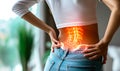 Woman in casual clothes suffering from chronic lower back pain, highlighted area showing lumbar spine and intestines, concept Royalty Free Stock Photo