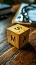 Wooden blocks spelling SMA, short for Spinal Muscular Atrophy, on a doctors desk with stethoscope and clipboard in the