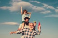 Generation of people and stages of growing up. Child pilot aviator with paper airplane dreams of traveling. Young boy Royalty Free Stock Photo