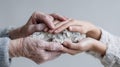 Generational connection: elderly and young hands holding stone with care and Royalty Free Stock Photo