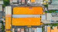 Generative AI Aerial view of a factory and its warehouses with yellow walls and an orange roof. The industrial are Royalty Free Stock Photo