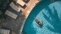 Generative AI Aerial view of a woman relaxing next the swimming pool in a luxury resort Antioquia Colombia busines