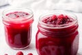Homemade Raspberry jam in glass jars on a white background. Selective focus. Generative AI Royalty Free Stock Photo