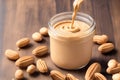 Peanut butter in a glass jar with peanuts on a wooden background. healthy food concept. Generative AI Royalty Free Stock Photo