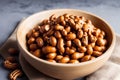 Roasted peanuts in white bowl on wooden background. Close up. Generative AI Royalty Free Stock Photo