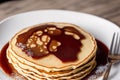 Stack of pancakes with maple syrup and sugar powder on a white plate. strawberries and whipped cream, Generative AI Royalty Free Stock Photo