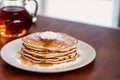 Stack of pancakes with maple syrup and sugar powder on a white plate. strawberries and whipped cream, Generative AI Royalty Free Stock Photo