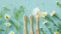 Generative AI Bamboo toothbrushes beautiful chamomile flowers sea salt and herbs on turquoise background flat lay Royalty Free Stock Photo