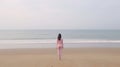 Generative AI Beautiful young sporty woman walks after running exercise on beach wears pink top demonstrates her p Royalty Free Stock Photo