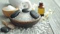 Generative AI beauty treatment items for spa procedures on white wooden table. massage stones, essential oils and Royalty Free Stock Photo