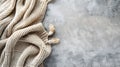 Generative AI Beige knitted blanket on gray concrete background with copy spaceAutumn winter  conceptFlat lay top Royalty Free Stock Photo