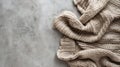 Generative AI Beige knitted blanket on gray concrete background with copy spaceAutumn winter  conceptFlat lay top Royalty Free Stock Photo