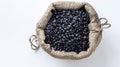 Generative AI Black bean in sack bag isolated on white background Top view Flat lay business concept.