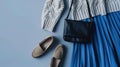 Generative AI Blue midi pleated skirt beige knitted sweater small black cross body bag belt loafers flat shoes on