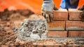 Generative AI Bricklayer laying brick on cement mix on construction site closeup Reduce the housing crisis by buil Royalty Free Stock Photo