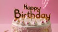 Generative AI Celebration birthday cake with pink and gold birthday candles spelling happy birthday against a pink Royalty Free Stock Photo