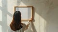 Generative AI Closeup of woman hanging square wooden frame with empty mockup copy space on wall Minimal art concep