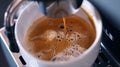 Generative AI coffee machine and cup of coffee with foam close up the process of making coffee in the coffee machi